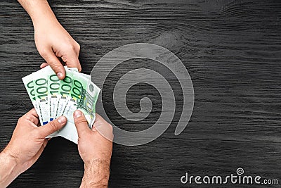 Money flow, hand-to-hand. Bribes or help. Crime to his charity. Top view Stock Photo