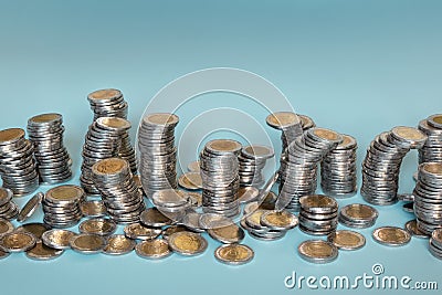 Money in form of unstable columns of coins. Saving money, business, finance, banking concept. Many coins in random piles Stock Photo