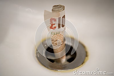 Money going down the drain Editorial Stock Photo