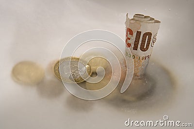 Money going down the drain Editorial Stock Photo