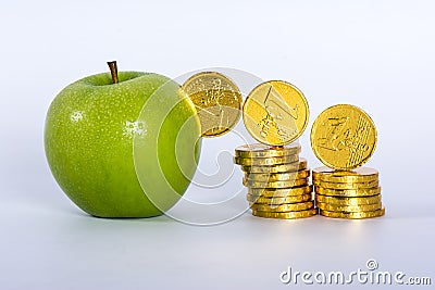 Money into green apple Stock Photo