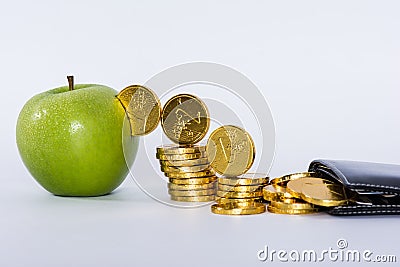 Money into green apple Stock Photo