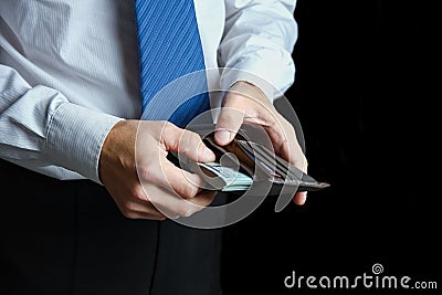 A money in the hands of a businessman in a crisis raising business concept bank worker Stock Photo