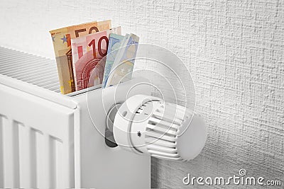 Money on heating battery Stock Photo