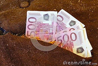 The money is hidden in the pillow of the old bed. Euro in the paneling of ancient furniture Stock Photo