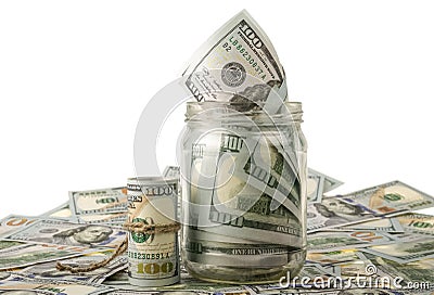 Money in the jar placing on US dollar banknotes Stock Photo