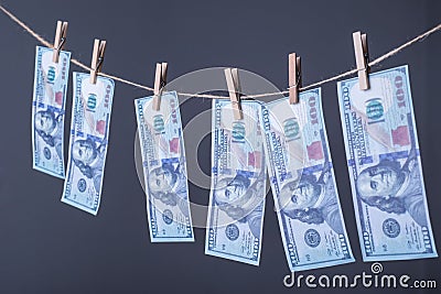 Close-up of money, dried on the ropes, fastened with clothespins. The concept of drying money. On a gray background Money Stock Photo