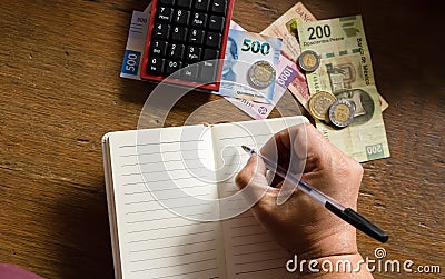 Money - Mexican pesos, making a budget Stock Photo