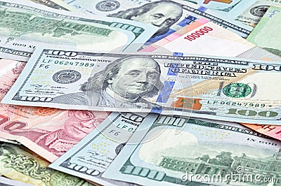 Money in multi currencies with 100 USD bill on top Stock Photo