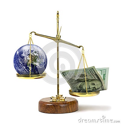 Money outweighing the earth on a scale representing greed & political corruption money being more powerful and important Stock Photo