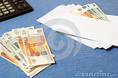 Money in the pile and the envelope with the bills. Stock Photo