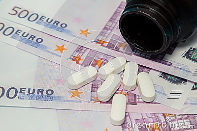 Money pills. Medicine pills on euro bills white medicine tablets on money. Covid-19 coronavirus pills are in euro money Stock Photo