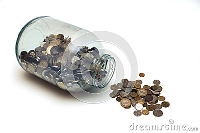 Money poured from a glass jar on a white background Stock Photo