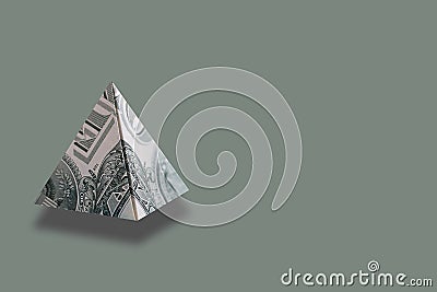 Money pyramid on green background. Copy space. Stock Photo
