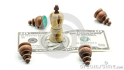 Money Rules: Pawns Lying Around A King Standing On A 10 Dollars Banknote Stock Photo