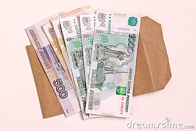 Money Russia. A stack of cash and an envelope on a white background. The concept of salary in an envelope. Stock Photo