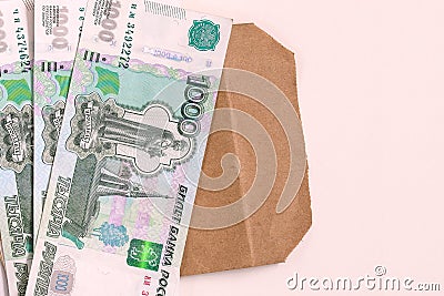 Money Russia. A stack of cash and an envelope on a white background. The concept of salary in an envelope. Stock Photo