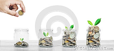 Money savings and business investment concept, bottle of coins on white wood on white background Stock Photo