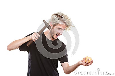 Sreaming man trying break piggy bank with hammer Stock Photo