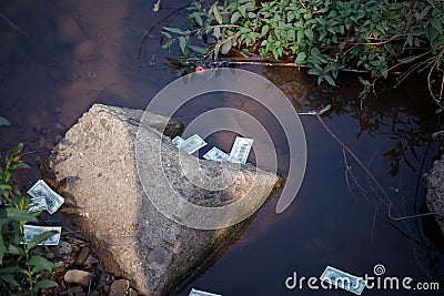 Money thrown into the water Stock Photo