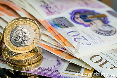 Money of United Kingdom close up on black background. Pounds UK 10 and 20 note and coins Editorial Stock Photo