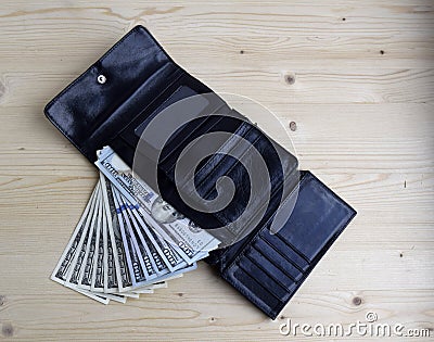 Money are in the wallet. American dollars banknotes. Each banknote a hundred dollars. Stock Photo