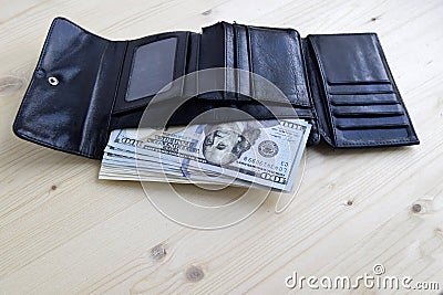 Money are in the wallet. American dollars banknotes. Each banknote a hundred dollars. Stock Photo