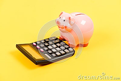 Moneybox with calculator. Piggy bank. income capital management. money saving. Accounting and payroll. bookkeeping Stock Photo