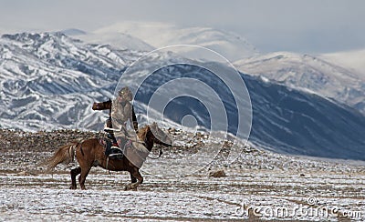 Mongolian horse rider in the mountains during the golden eagle festival Editorial Stock Photo