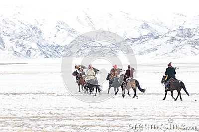Mongolian horse riders in the mountains during the golden eagle festival Editorial Stock Photo