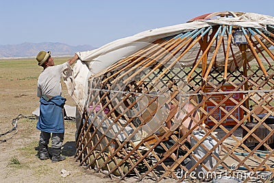 Mongolian men assemble yurt in steppe, circa Harhorin, Mongolia. Editorial Stock Photo