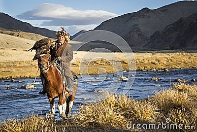 Mongolian nomad eagle hunter on his horse Editorial Stock Photo