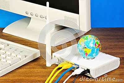Monitor and keyboard for your computer. A router for connecting to the Internet. Stock Photo