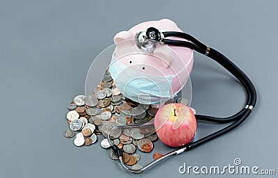 Monitoring the health of the economy with piggybank and medical Stock Photo