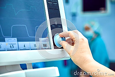Monitoring patient`s vital sign in operating room. doctor cheking at patient`s vital signs. Cardiogram monitor during Stock Photo