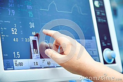 Monitoring patient`s vital sign in operating room. doctor cheking at patient`s vital signs. Cardiogram monitor during Stock Photo