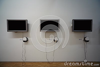 Monitors and headphones on the wall. Stock Photo