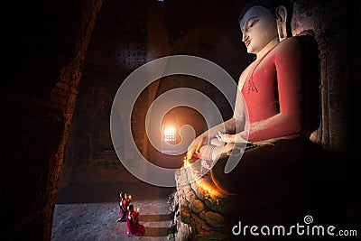 Monk in Bagan old town pray a buddha statue Editorial Stock Photo