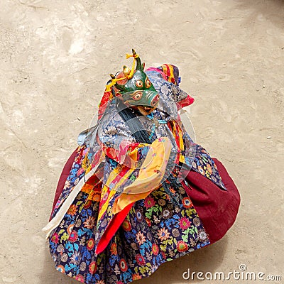 Monk in a bull deity mask with ritual dagger phurpa performs a religious masked and costumed Cham dance of Tibetan Buddhism Stock Photo