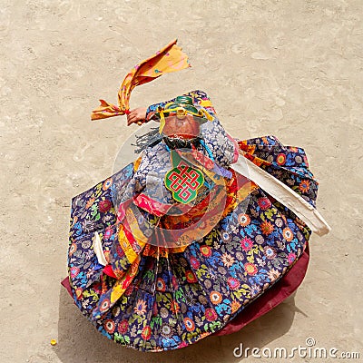 Monk in a bull deity mask with ritual dagger phurpa performs a religious masked and costumed Cham dance of Tibetan Buddhism Stock Photo