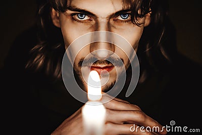 A monk with a candle Stock Photo