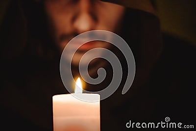 A monk with a candle Stock Photo