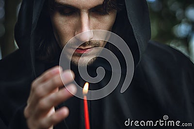 A monk with a candle Stock Photo