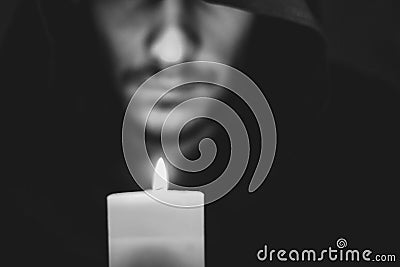 A monk with a candle Stock Photo