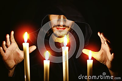 A monk with a candle Stock Photo