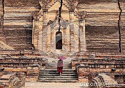 A monk coming to ancient pagoda in Mandalay, Myanmar Editorial Stock Photo
