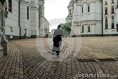 Monk crossing himself in the yard of Kyiv Pechersk Lavra Editorial Stock Photo