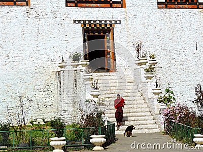 Monk at the entrance of Simtokha Dzong in Bhutan Editorial Stock Photo