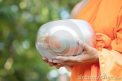 Monk with hand holding give alms bowl which came out of the offerings in the morning at Buddhist temple, Culture Heritage Site tra Stock Photo