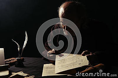 monk holding wax seal and manuscripts Stock Photo